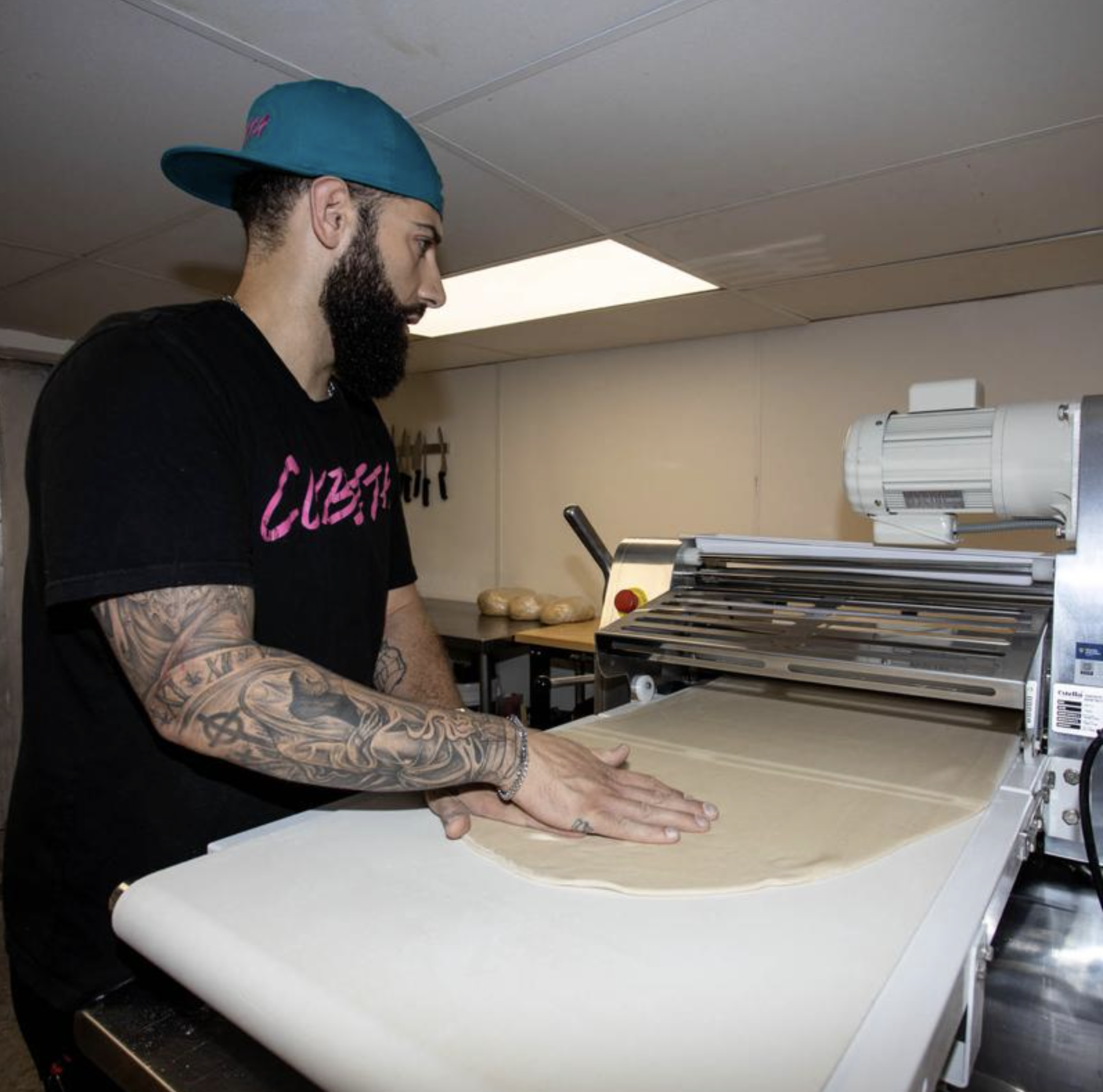 Gus rolling empanada dough at Cubita Café