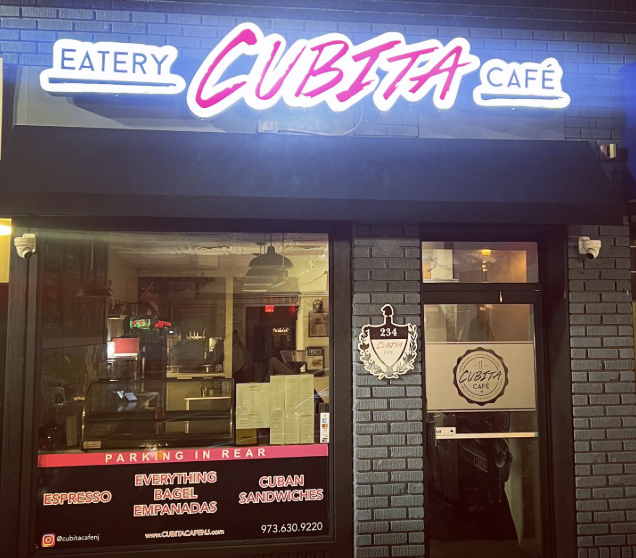 Cubita Café storefront at night with neon sign